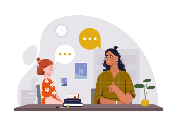 A young girl speaks with a female teacher across a desk in a calm office setting, with books and speech bubbles shown, symbolizing communication. Vector illustration